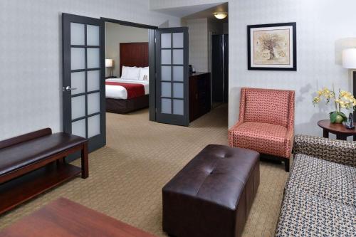 a hotel room with a bed and a living room at Comfort Suites Airport Tukwila Seattle in Tukwila