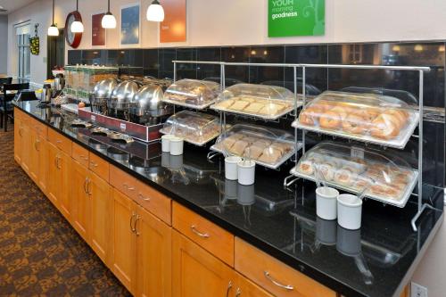 a buffet line with many trays of pastries at Comfort Suites Airport Tukwila Seattle in Tukwila