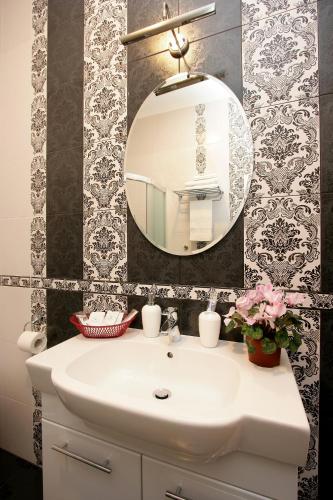 a bathroom with a white sink and a mirror at Hotel Litera in Dnipro