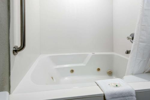 a white bath tub in a bathroom with a towel at Quality Inn & Suites Brownsburg - Indianapolis West in Brownsburg