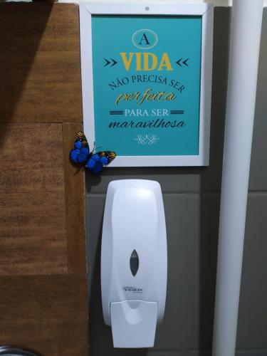 a butterfly is sitting on top of a white electronic device at Hostel Portal Das Fadas in Cavalcante