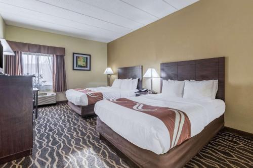a hotel room with two beds and a television at Quality Inn & Suites Southport in Indianapolis