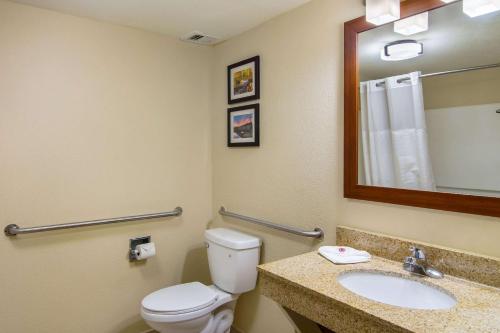 a bathroom with a toilet and a sink and a mirror at Comfort Inn Acworth - Kennesaw Northwest in Acworth