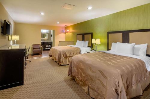 A bed or beds in a room at Quality Inn