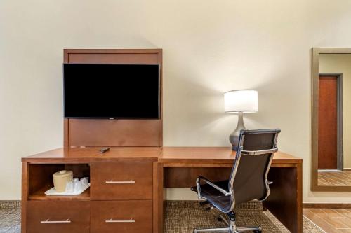 a desk with a television and a chair in a room at Comfort Suites San Antonio Ft Sam Houston-SAMMC Area in San Antonio