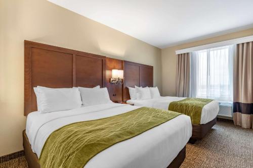 a hotel room with two beds and a window at Comfort Suites San Antonio Ft Sam Houston-SAMMC Area in San Antonio