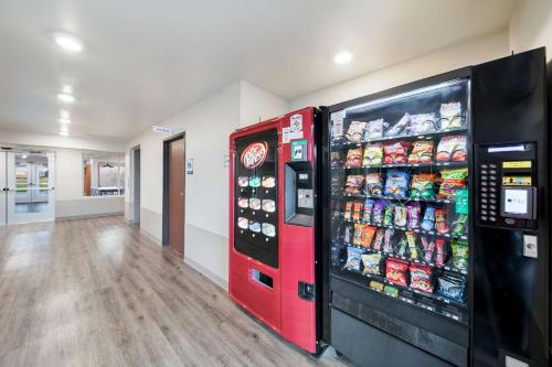 a red vending machine in a room with soda at WoodSpring Suites Dallas Plano Central Legacy Drive in Plano