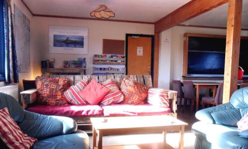 a living room with couches and a flat screen tv at Anglesey Outdoors in Holyhead