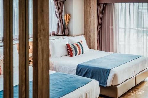 Cama ou camas em um quarto em So Boutique Pattaya Hotel & Residence