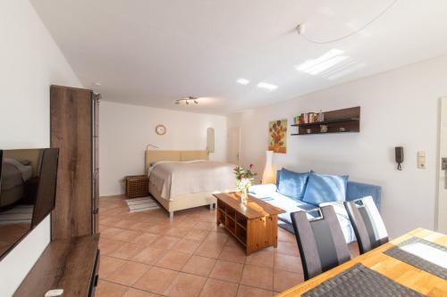 a living room with a bed and a table at Ferienwohnung Kruppa in Plön