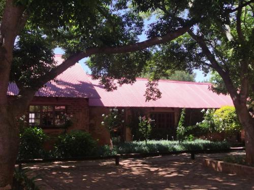 a building with a red roof at Critchley Hackle Dullstroom Leisure in Dullstroom