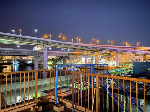 a bridge over a river at night with cars at GUEST HOUSE APPLE in Osaka