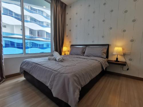 a bedroom with a large bed and a large window at Thermospace The Wave B-13A-13 Melaka City in Melaka