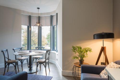 a dining room with a table and chairs at Park Lane Aparthotel by Urban Space in Cardiff