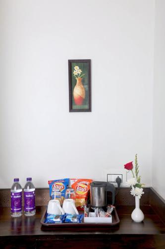 a table with a tray of food and drinks at Hotel Planet Four in Lonavala