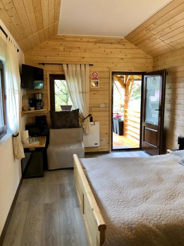 a bedroom with a bed and a couch in a room at Domeniul Horj Casa din Cireș Moisei in Moisei
