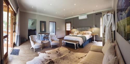 a bedroom with a bed and a living room at Villiera Guesthouse in Douglas
