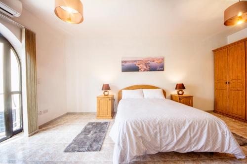 a bedroom with a large bed and two night stands at Central 3 Bedroom Entire Apartment Msida in Msida