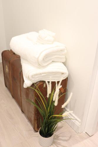 a stack of towels sitting on top of a suitcase at The Cottage get away in Saffron Walden