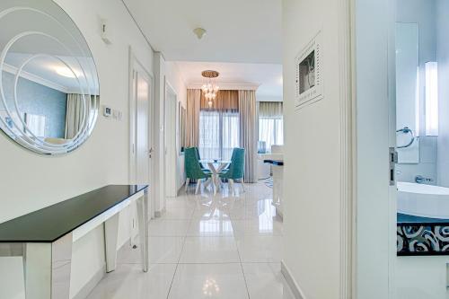 a white bathroom with a sink and a mirror at Remarkable apartment in Downtown near Dubai Mall in Dubai