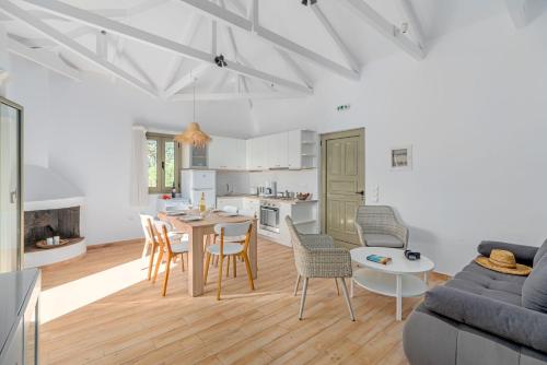 a kitchen and living room with a table and chairs at Kosyforema Villas in Gialova