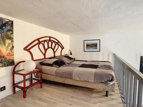 a bedroom with a large bed and a staircase at Cosy studio Perpignan in Perpignan