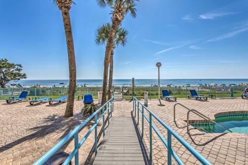 a stairway leading to a beach with palm trees at Steps to Boardwalk Condo with Pool in Myrtle Beach in Myrtle Beach