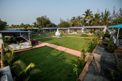 an aerial view of a house with a garden at Treebo Lands End Beach Resort Morjim in Morjim