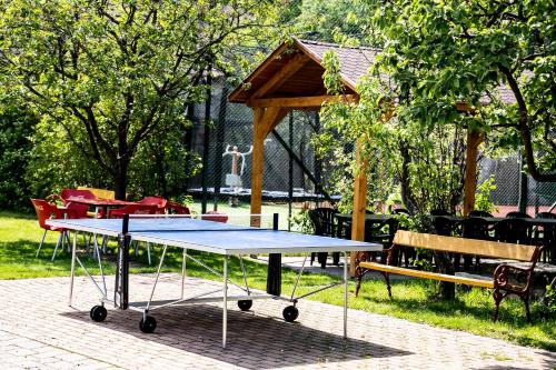 a ping pong table in a park with a gazebo at Aranybánya Panzió és Apartmanház in Telkibánya