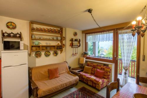 a living room with a couch and a window at ALTIDO Apt for 7 with Terrace and Exceptional Location in Courmayeur