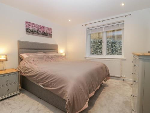 a bedroom with a large bed and a window at Flat 2, 38 Preston Road in Weymouth