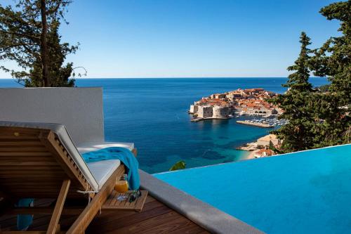 a swimming pool with a view of the ocean at Villa T Dubrovnik - Wellness and Spa Luxury Villa with spectacular Old Town view in Dubrovnik