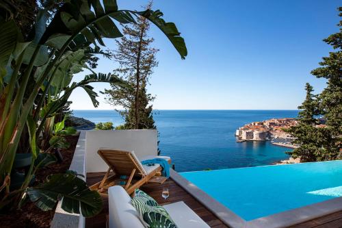 a view of the ocean from a villa with a swimming pool at Villa T Dubrovnik - Wellness and Spa Luxury Villa with spectacular Old Town view in Dubrovnik