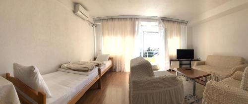 a room with a bed and a chair and a window at Hotel Venecia Apartments in Struga