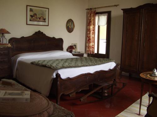 a bedroom with a bed and a dresser and a window at B&B Casa Manuelli in Alessandria