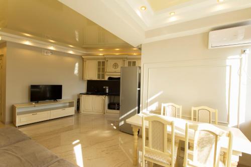 a kitchen and living room with a table and chairs at Residential Сomplex Central 270 in Almaty