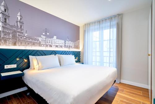 En eller flere senge i et værelse på Tandem Torres de Cádiz Suites