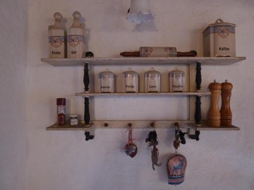 a wall with wooden shelves with clocks on it at Heuholzmühle Privatzimmer in Elixhausen