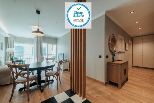 a dining room and living room with a table and chairs at City Garden by Madeira Best Apartments in Funchal