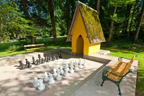 a large chess board in front of a play house at Naturhotel Schloss Kassegg in Sankt Gallen