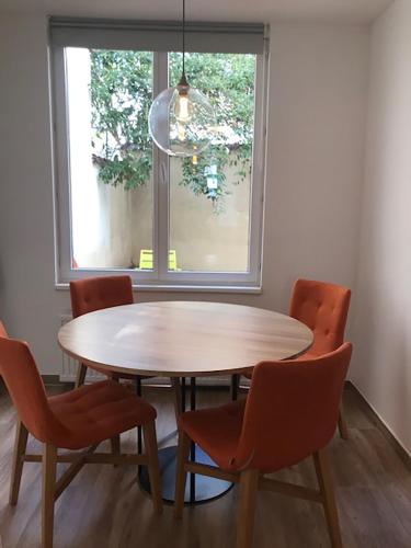 a table and chairs in a room with a window at Brussel House Basilic in Brussels