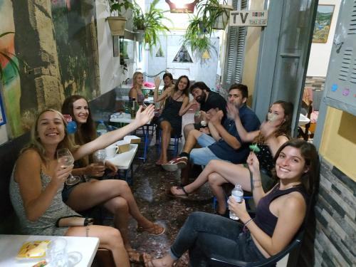 a group of people sitting in a bar with wine glasses at Pagration Youth Hostel in Athens