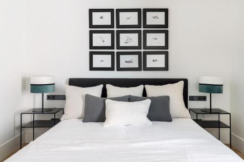 a bedroom with a white bed with two lamps at Hotel Bodega Tio Pepe in Jerez de la Frontera