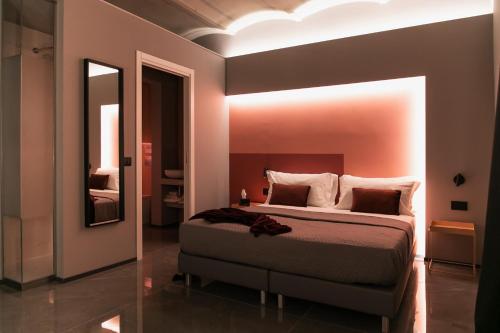 a bedroom with a large bed and a mirror at WeLive in Carpi