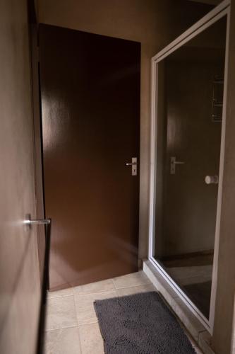 a door in a room with a rug next to it at Camdeboo Place in Dullstroom