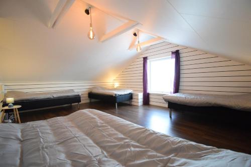 a attic room with a bed and a window at Big Apartment in central Kiruna 5 in Kiruna