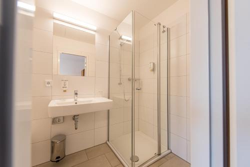 a bathroom with a sink and a shower at Evangelische Tagungsstätte Hofgeismar in Hofgeismar