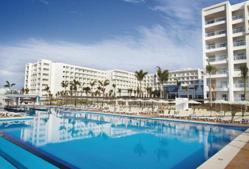a large swimming pool in front of a hotel at Riu Playa Blanca - All Inclusive in Playa Blanca