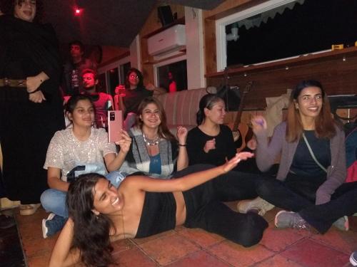 a group of women sitting on the floor at a party at Hotel Kasauli Regency Stags Not Allowed in Kasauli