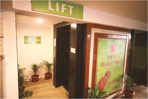 an entrance to an office with potted plants at Apples Balaji Inn in Siliguri